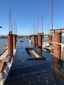 Polyurea applied to Grant Street Pier in Vancouver to protect concrete coloring from water discoloration.